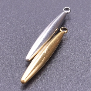 Macro view of gold and silver bullet shaped 304 stainless steel jewelry pendants