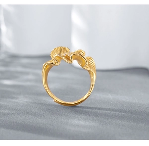 Detailed macro of golden wavy pleated ring featuring interior zircon inlay details