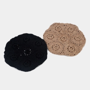 Close-up of handmade crochet hollow floral pattern on cotton knit beret hats