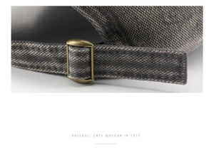 Detail of vintage bronze buckle and adjustable strap on a gray washed baseball cap