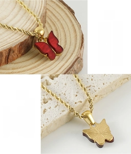 Detail of red butterfly pendant on golden twisted rope chain with 365-day color retention