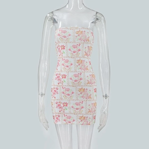 Close-up of white tube dress with pink floral prints and golden chain patterns