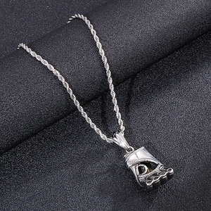 Macro detail of a polished silver boxing glove pendant with textured metal finish