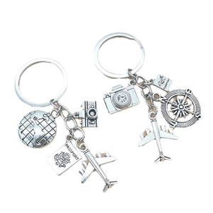 Silver travel-themed keychain set with globe, camera, plane, and compass charms