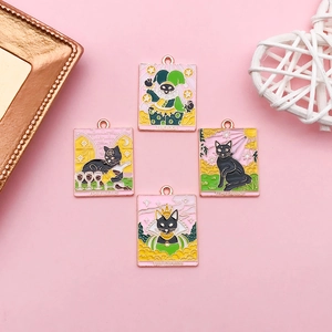 Detailed view of four black cat tarot charms with pink enamel and gold-plated frames