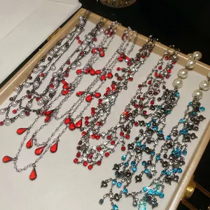 Luxe rhinestone pearl necklace set with colorful crystal pendants in a beige jewelry box
