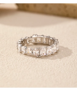 Macro shot of s925 silver eternity ring with sparkling oval-cut clear gemstones
