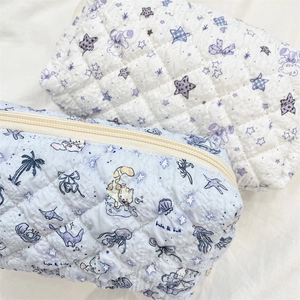 Close-up of quilted floral pencil cases with smooth zippers and cotton texture detail