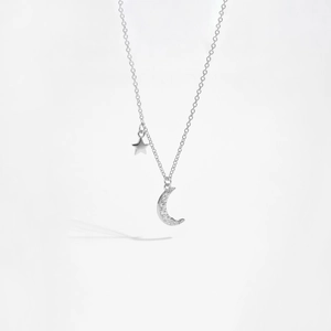 Macro shot of S925 sterling silver moon and star pendant necklace with cubic zirconia