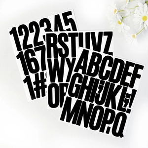 Close-up of 3-inch black vinyl letter and number stickers with daisy decor