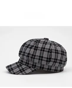 Side view of black and white plaid newsboy cap with classic British woven texture