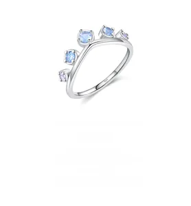 Detail of S925 sterling silver crown ring with light blue gemstones and hallmark