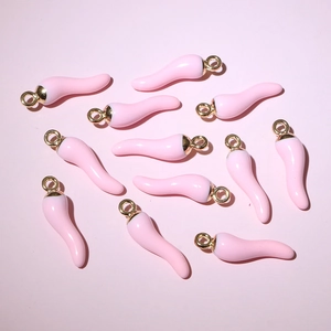 Detailed flat lay of pink zinc alloy chili pendants for DIY jewelry crafting
