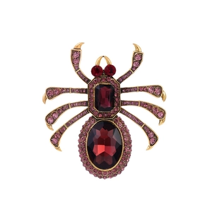 Vintage gold spider brooch with deep red crystals and purple rhinestone accents on legs