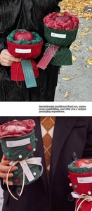 Detail of Christmas apple gift wrapping with red and green knit covers and festive tags