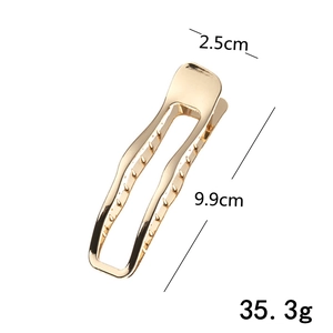Detailed view of 9.9cm gold metal claw clip showing dimensions 9.9cm by 2.5cm and weight