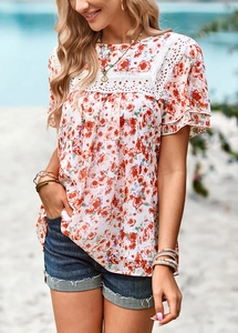 Close-up of floral chiffon top featuring delicate white lace stitching and ruffle sleeves