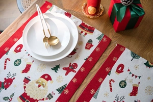 Close-up of festive Christmas placemat with Santa and reindeer on wooden table
