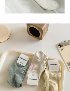 Detailed view of combed cotton low cut socks with ribbed cuffs in soft pastel colors