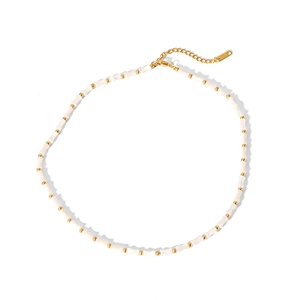 Detail of French vintage necklace with bamboo-style shell beads and gold plated chain