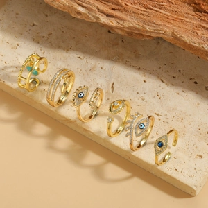 Set of 6 gold adjustable evil eye rings with blue crystals on natural stone