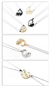 Detail view of interlocking black and gold cat pendants for couples necklaces in steel