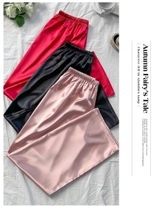 Detail view of satin silk lounge pants in red black and pink with elastic waistband