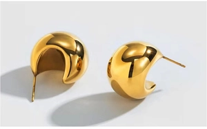 Close-up of thick 18K gold-plated stainless steel hoop earrings on grey background