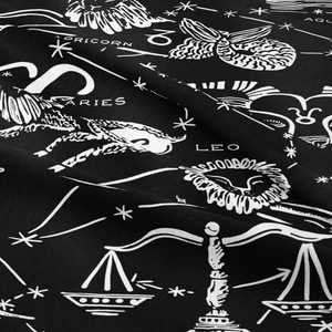 Detail of zodiac signs print on black fabric tapestry with high quality texture