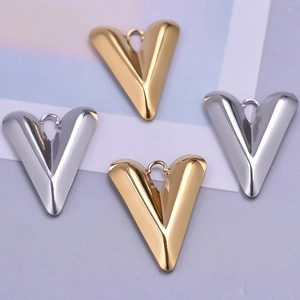 Detailed macro view of 304 stainless steel V-shaped heart pendants in gold and silver