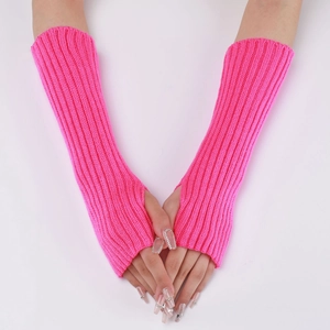 Detail of neon pink knitted arm warmers with fingerless design and thumb hole