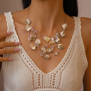 Close-up of multi-layer crystal beaded shell necklace with iridescent pearl finish