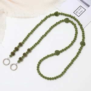 Detail of green plush heart beads phone strap with silver metal round ring buckles
