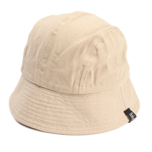 Detail of minimalist beige cotton bucket hat with a black square fabric label