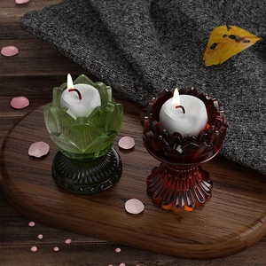 Detailed view of lotus flower glass candle holders in green and reddish-brown colors