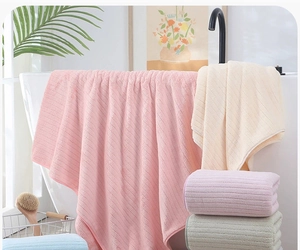 Detailed view of checkered coral fleece bath towels with absorbent ribbed texture in pastel tones