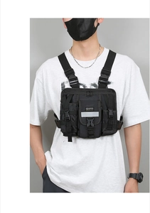 Close-up of black tactical chest bag showing high-density nylon fabric and reflective strip