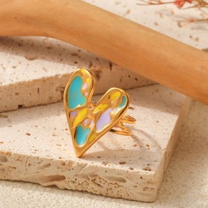 Artistic gold plated heart ring with colorful enamel inlay on travertine stone