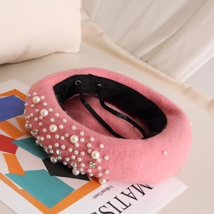Detail of pink wool beret featuring elegant pearls, rhinestones, and adjustable inner strap