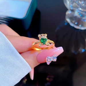 Delicate gold-plated open bear ring featuring a green heart gemstone and zircon stones
