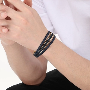 Close-up of men's multi-layer blue woven leather bracelet with gold metal beads