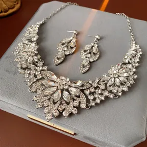 Elegant silver floral jewelry set with marquise rhinestones on a gray velvet display box