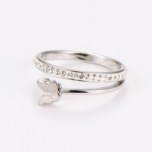 Macro shot of silver butterfly ring featuring double band design and micro-pave crystals
