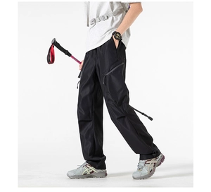 Detail of cargo pants showing side multi-pocket structure and tactical zipper design