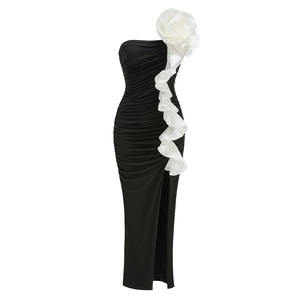 Detail of black strapless mermaid dress with large white floral accent and side ruffle