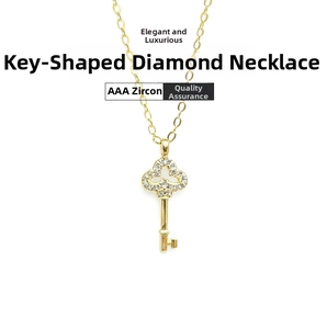 Detail of clover key pendant in gold finish featuring micro-set AAA zircons
