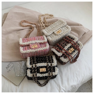 Detail of tweed mini flap bags with pearl trim and chain straps in multiple colors