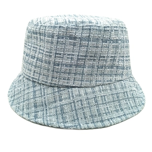 Detailed view of blue and white tweed texture on a stylish bucket hat fabric