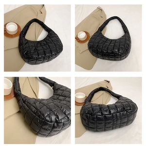 Close-up of black quilted shoulder bag featuring retro diamond stitching and puffer texture