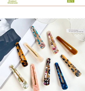 Macro view of acetate duckbill hair clips in tortoiseshell and marble textures